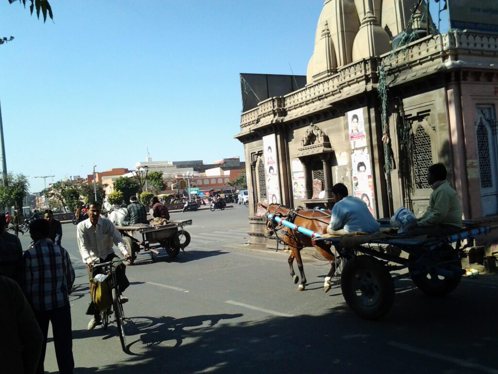 A scene in Jaipur with a temple in the road