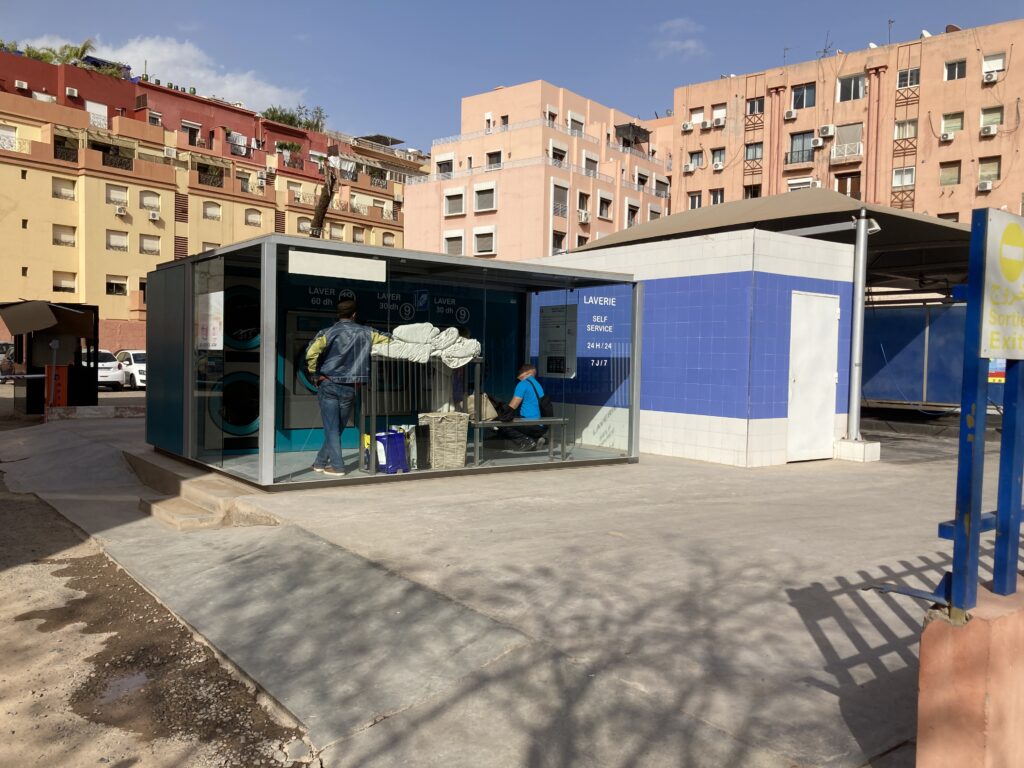 A self service laundromat, “lavarie automatique” run by a local chain, White Factory.