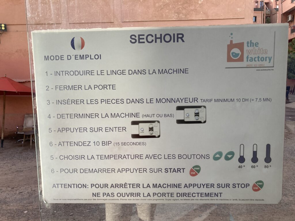 A self service laundromat, “lavarie automatique” run by a local chain, White Factory.