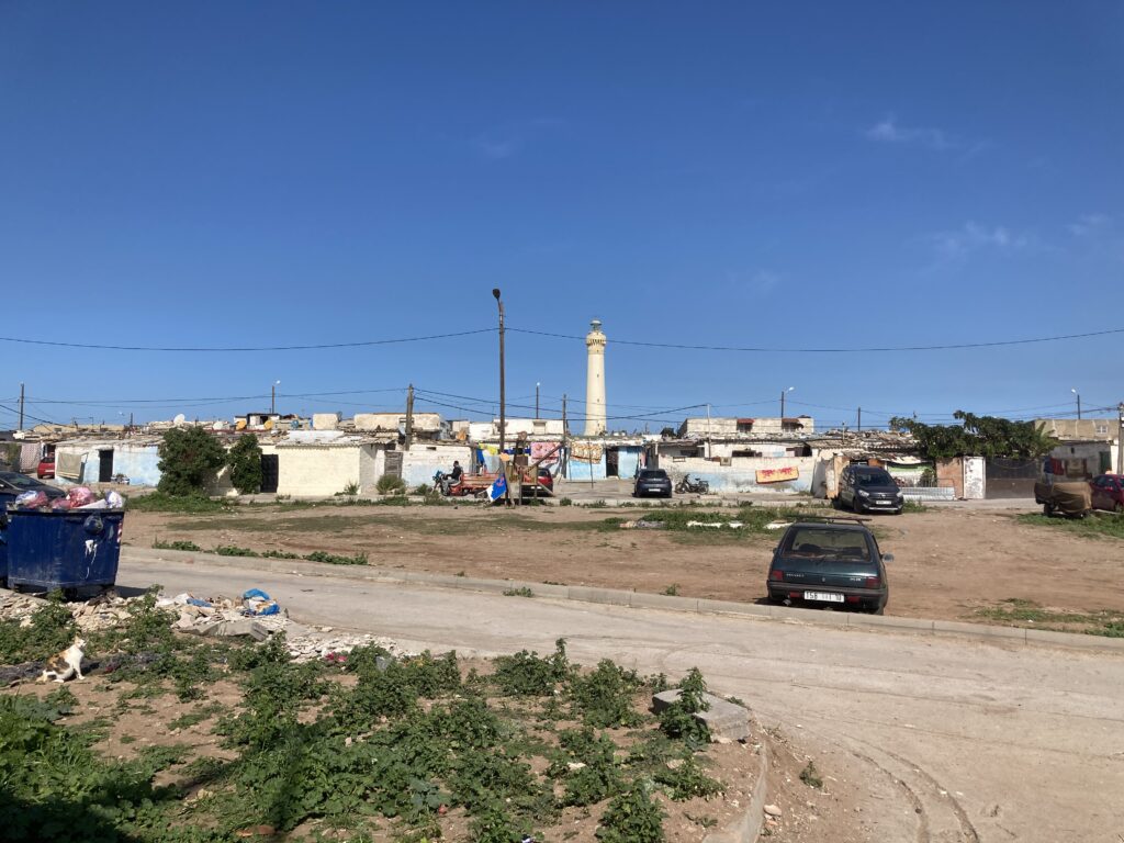 A view of the El Hank Lighthouse with a neighborhood in the foreground as seen from Boulevard de la Corniche