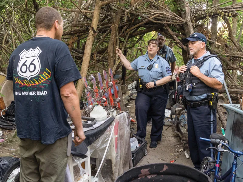 Sgt. Angela Joyce and Officer Terry Grimes of the Kansas City, Kansas Police Department perform frequent wellness checks at homeless encampments. Their job is to work with outreach teams to solve problems. But Joyce is among the officers who believe that policing shouldn’t be the primary solution to unsheltered homelessness. Credit: Jeff Tuttle