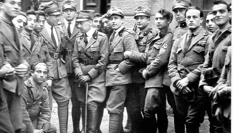 Gabriele D'Annunzio (in the middle with the stick) with some legionaries (components of the Arditi's department of the Italian Royal Army) in Fiume in 1919. To the right of D'Annunzio, facing him, Lt. Arturo Avolio (commander of the Ardit's department of Bologna Brigade).